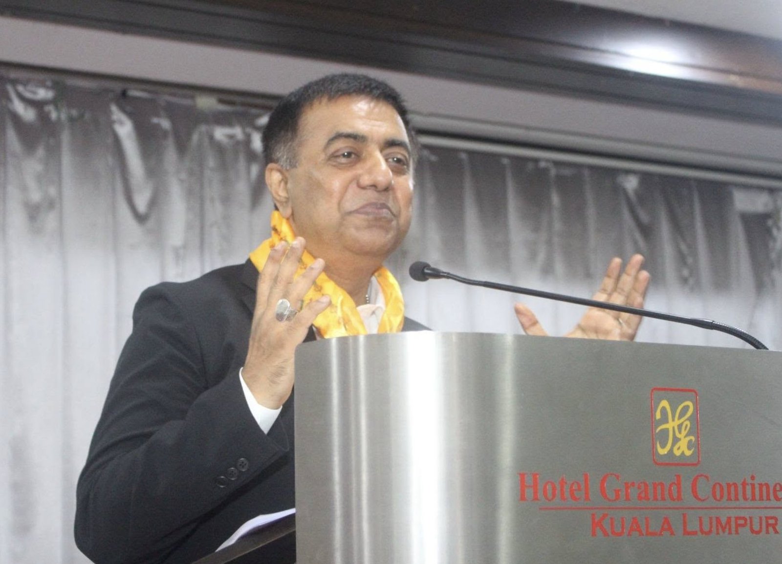 Mahbub Alam speaking at a podium in Kuala Lumpur